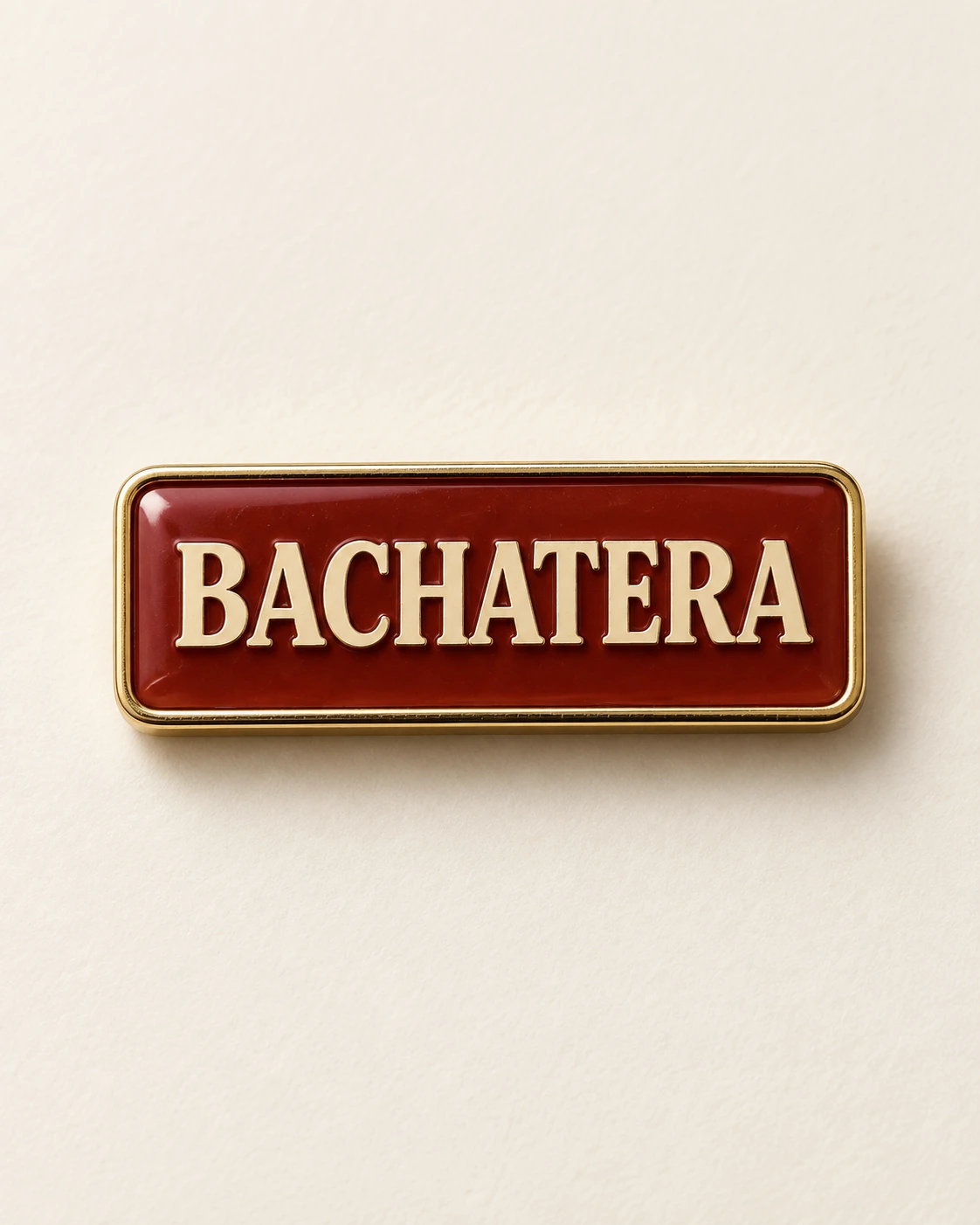 Individual Bachatera red and gold enamel pin concept on ivory.