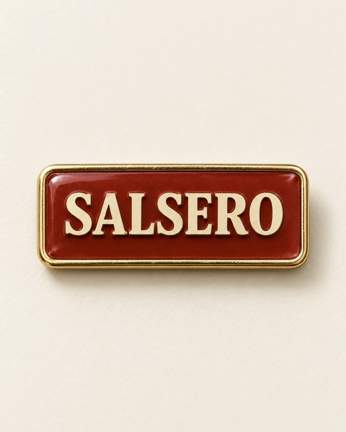 Individual Salsero red and gold enamel pin concept on ivory.